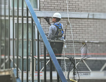 Documenting conditions during a hands-on Facade Inspection Safety Program examination.