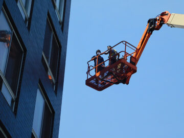 Facade Inspection Safety Program (FISP) hand-on inspection by boom lift