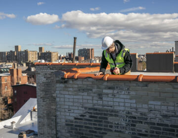 Engineering conducting a parapet inspection per New York City's new annual parapet inspection requirement.