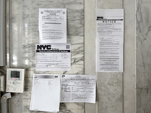 Department of Building notices posted prominently in lobby of a building.